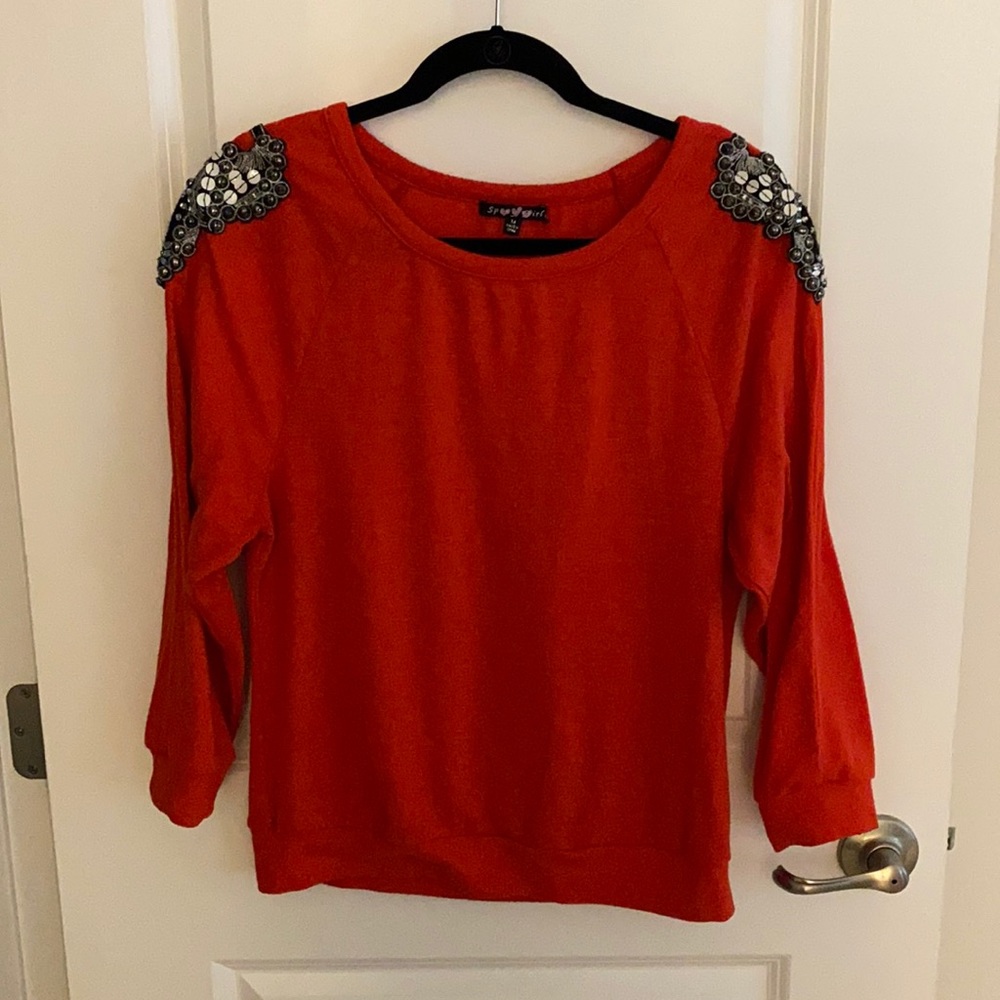 ...red top with embellishments.